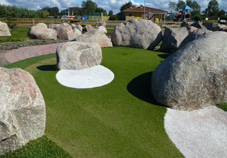 Large stones around the adventure golf hole